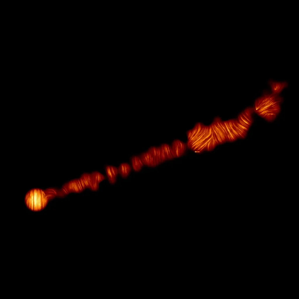 Questa immagine mostra il getto nella galassia M87 in luce polarizzata, catturato da ALMA. Questa immagine rivela la struttura del campo magnetico lungo il getto. Credit: ALMA